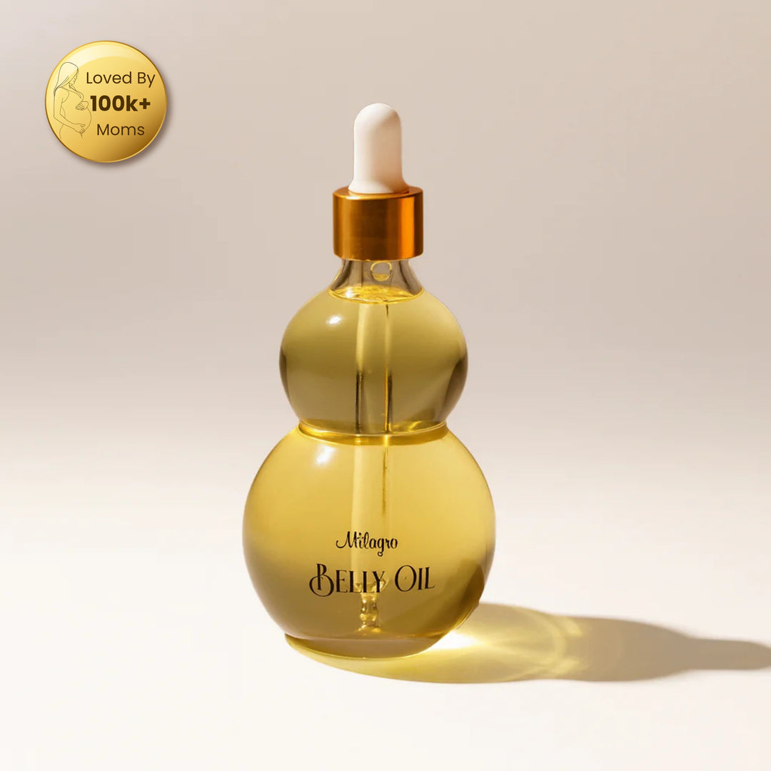 Belly oil dropper bottle with gold cap on a beige background, featuring a badge indicating popularity among moms.